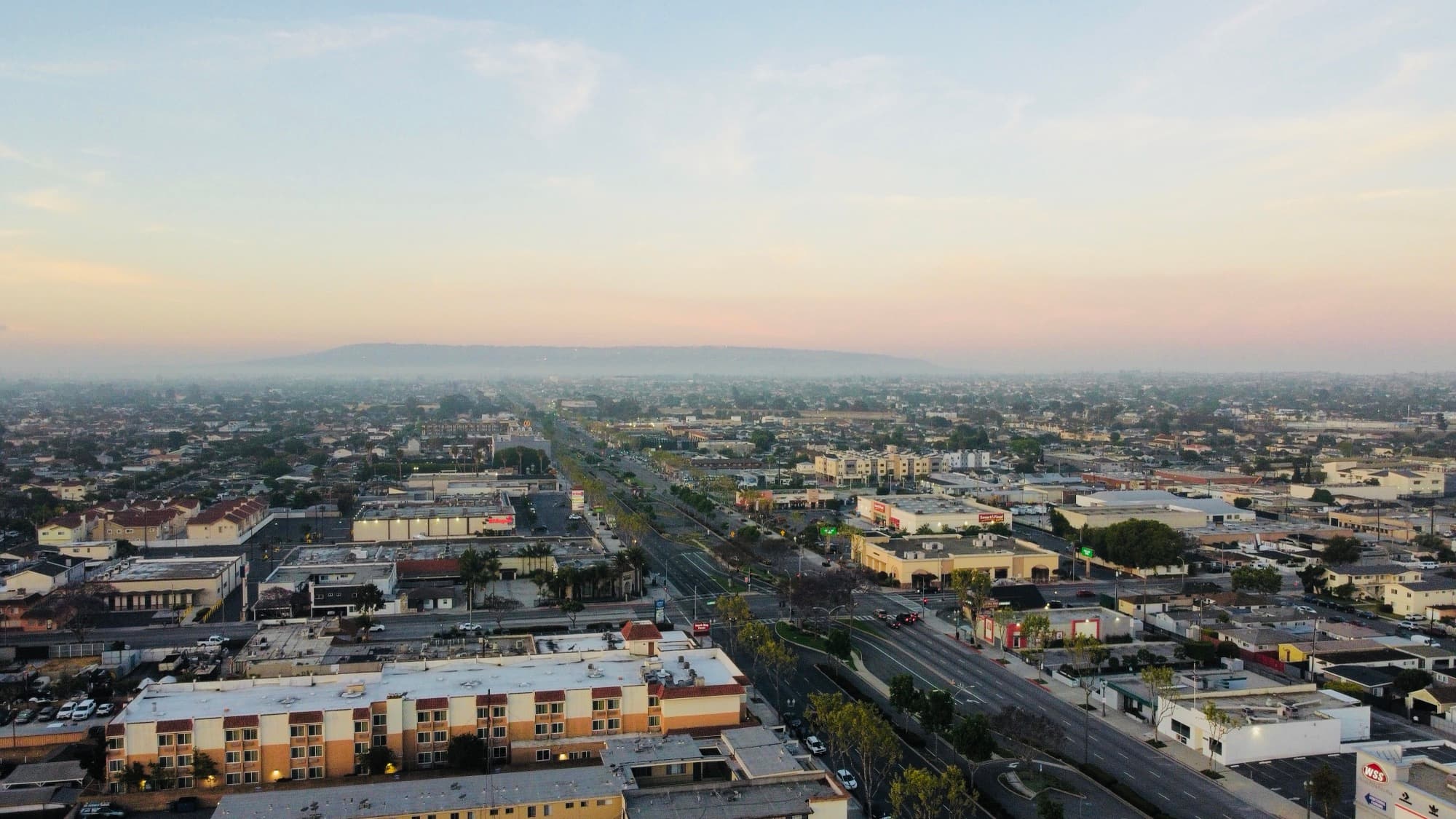 A city street grid photographed from the air at dawn